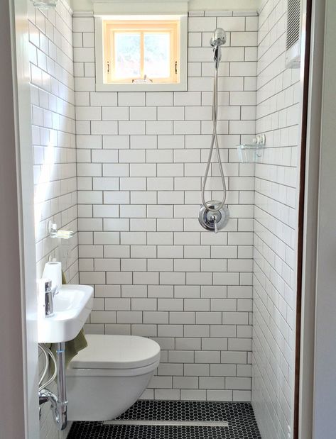 tiny bathroom, wall hung toilet and sink, subway tile, black hex floor tile, strip drain, compact modern bathroom Bathroom Wet Wall, Wet Bathroom Ideas, Tiny Shower Room, Tiny House Shower, Tiny Wet Room, Small Wet Room, Dekorere Bad, Bilik Air, Small Shower Room