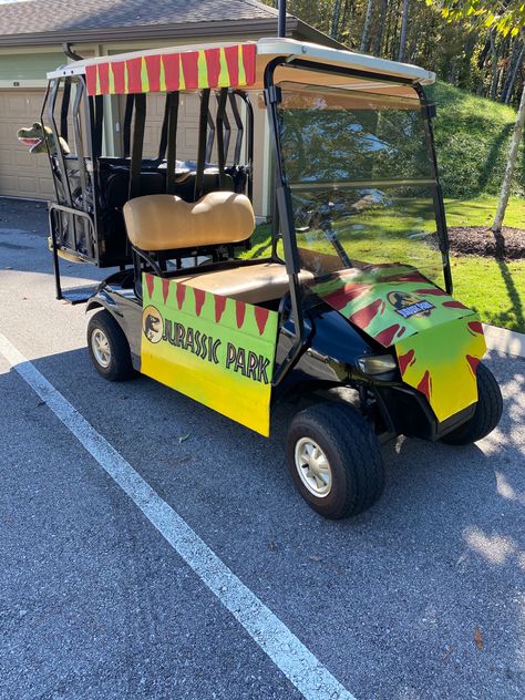 Trunk Or Treat For Golf Carts, Golf Cart Costume Ideas, Jurassic Park Golf Cart Decorations, Family Halloween Costumes With Golf Cart, Golf Cart Theme Ideas, Safari Golf Cart Decorations, Diy Halloween Golf Cart Decorations, Golf Cart Float Ideas, Jurassic Park Golf Cart