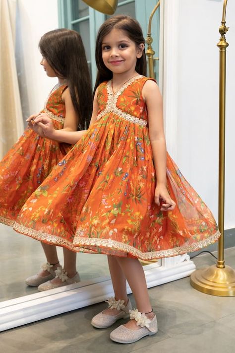 Burnt orange organza tunic style dress with all over contrast multi color floral print, pleated flare and metallic gota embroidered border details. - Aza Fashions Couture, Girls Indian Dresses Kids, Orange Toddler Dress, Organza Frocks For Kids, Organza Tunic, Frock For Kids, Long Frocks For Kids, Indian Frocks, Navratri Jewellery