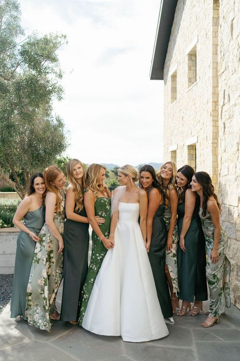 classic bride in an elegant strapless wedding dress with her bridal party in mismatched floral and solid green bridesmaid dresses Elegant Green Bridesmaid Dresses, Greenery And White Wedding Bridesmaids, Wedding Party Mismatched Dresses, Mismatched Bridesmaid Dresses And Groomsmen, Garden Theme Wedding Bridesmaid Dresses, Sage Green Mismatched Bridesmaids, Dark Green Mix And Match Bridesmaid Dresses, Mix Matched Wedding Party, Bridesmaid Dresses Mismatched Floral