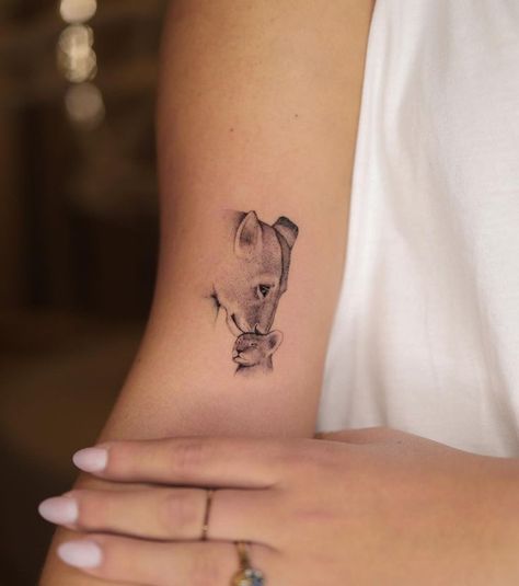 Stylish and Meaningful Motherhood Tattoo Ideas Mother Daughter Lion Tattoos, Protective Mother Tattoo, Lioness Tattoo Small, Mom Tattoo For Sons, Lioness Cubs Tattoo, Lion And Baby Tattoo, Motherly Tattoo, Lions Family Tattoo, Baby Cub Tattoo