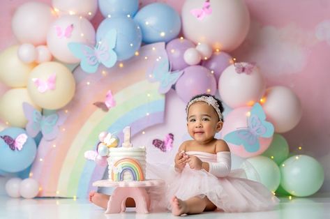 Smash Cake Colorful, Butterflies And Rainbows Birthday, Pastel Rainbow Photoshoot, First Birthday Pastel Rainbow Theme, Rainbow Birthday Photoshoot, Colourful Cakes Birthday, Pastel Rainbow Cake Smash, First Birthday Rainbow Theme, Rainbow Balloon Backdrop