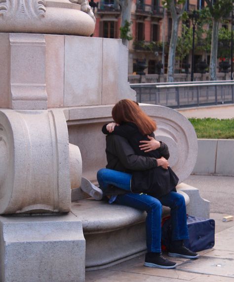 Near the Arc de Triomf, a young couple sit entwined, hugging each other, in a city where displaying love and affection is normal and encouraged. Hugging While Sitting Couples, Tightly Hug Sleep Couple, Sitting Hug Couple, Sitting On Lap Couple Pose Drawing, Straddle Hug Sitting, Sitting On Lap Hugging, Deep Hugs Couple, Hug Sleep Couple, Hugging Couple Drawing