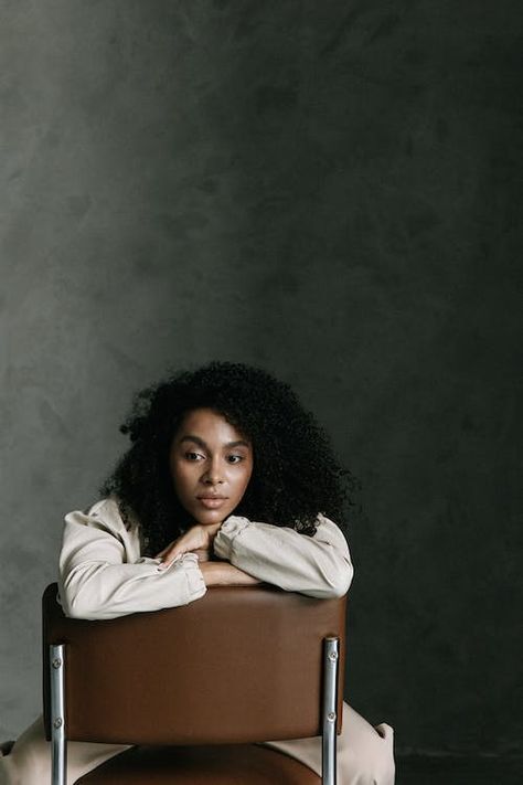 A Woman Sitting on a Chair · Free Stock Photo Hair Chair, Chair Concept, High Fashion Poses, Chair Pose, Studio Poses, Sitting Poses, Woman Sitting, Afro Hair, Photoshoot Concept