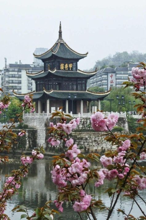 Jiaxiu Pavilion of Guiyang City is built on the Nanming River in the south of the city, with a huge stone for a base. It's a symbol of the city, and anyone who has ever been to Guiyang will climb the pavilion to see the scenery. The building was built during the Wanli period of the Ming Dynasty (1598) and the existing structure was reconstructed during the Xuan Tong period of the Qing Dynasty (1909). Pic by photographer Han Guiqun. Climbing, Guiyang, China, The Pavilion, Ming Dynasty, Qing Dynasty, The Building, The South, The City