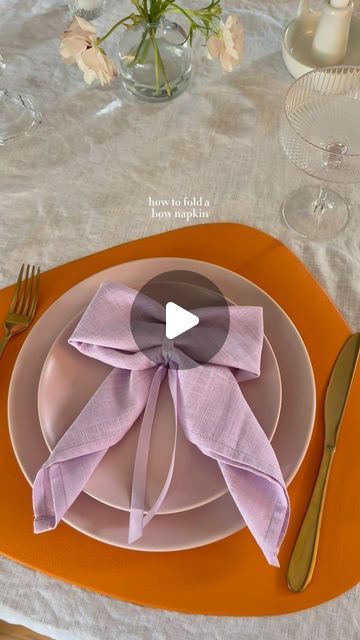 Ashley Tassano on Instagram: "I decided to add this bow napkin last minute, and I’m so happy I did. Not only was it simple, but everyone loved it! You could also make these with a napkin ring or a clear elastic instead of the ribbon.   Tip: Save the ribbon to use again or add it to glassware for your next event. ✨  #coquette #bows #napkinfolding #tablescapes #tablescapestyling #tablescapetuesday #discover"