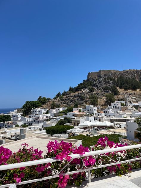 View of Lindos village on the Greek island Rhodes with the view of its cliff top acropolis. Beautiful white town. White washed houses. Greece Rhodes, Gap Year Travel, Rhodes Island, Sun Aesthetic, Beautiful Cities, Visiting Greece, Gap Year, Greek Island, Beautiful Places In The World