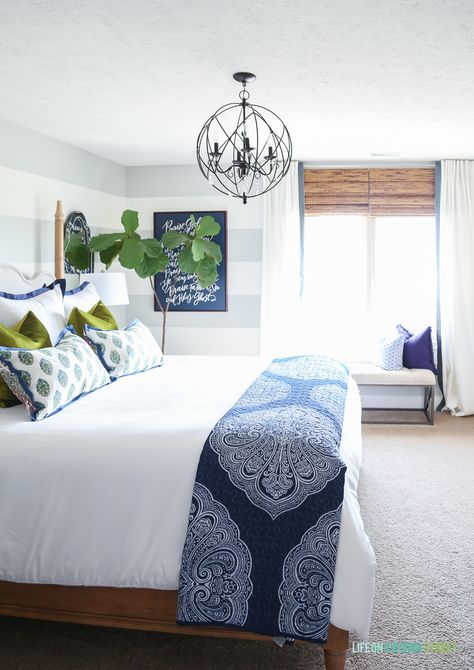 Guest bedroom with woven shades, ribbon trimmed drapes, white bedding, navy blue paisley throw, Doxology canvas, fiddle leaf fig tree, chartreuse velvet pillows and hickory wood bed via Decked and Styled Spring Home Tour - Life On Virginia Street Guest Bedrooms, White Bed, Design Blogs, Blue Spring, Bedroom Color Schemes, Dreamy Bedrooms, Spring Home Decor, White Bedroom, White Bedding