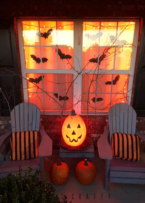 Halloween porch with orange lights at night Halloween Night Decorations, Screened In Porch Halloween Decorations, Halloween Decor Outside Front Porches, Halloween Porch Party, Halloween Decorations Lights Outdoor, Cute Yard Halloween Decorations, Halloween Themed Front Porch, Halloween Porch Pumpkins, Diy Halloween Decorations For Porch