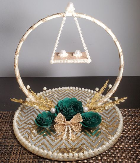 This embellished glass ring holder is the perfect accessory for your wedding/engagement celebrations! Can be used to display his and her rings at an engagement or wedding.  This ring holder features an 8in glass mirror plate with a gold chevron design. The extended hoop is approximately 6in in diameter, and the pearls posts on the swing are designed to accommodate all ring sizes and styles. Rings will not fall off the swing as they will fit onto the posts in an elegant manner. Please message me for customizations. The following customization options are available, free of additional cost: - Rose Color: You may chose up to two rose colors. If you send me an image of your outfit or decor, I can color match. - Use a Plain Mirror Plate as a Base: If you are not a fan of the mirror plate with t Engagement Ring Plate, Wedding Ring Pillow Diy, His And Her Rings, Nikkah Wedding, Engagement Ring Holder, Engagement Ring Platter, Wedding Gift Hampers, Ring Platter, Engagement Ring Holders