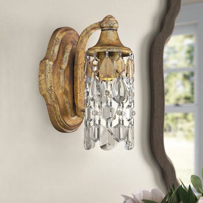 This 1-light wall sconce features crystal accents that give your space a touch of French country style. The metal backplate strikes an oval-shaped silhouette, and it features raised quatrefoil-style moldings for a classic look. A scrolled arm connects to a downturned bell fixture that accommodates one candelabra-style bulb up to 60W (not included). The dangling crystal accents give this candle wall light a hint of glam design. Plus, this fixture is ideal for adding to damp locations like the bat French Country Bathroom, Modern French Country, Kelly Clarkson Home, Crystal Wall Sconces, Bathroom Wall Sconces, Crystal Wall, Barn Lighting, Wall Candles, Kelly Clarkson