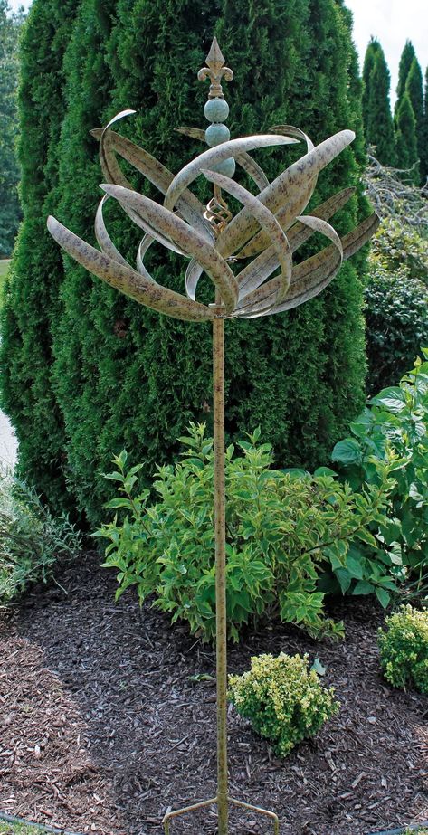 PRICES MAY VARY. Amazing, horizontal wind spinner adds movement to your garden Mottled green and brown finish evokes aquatic plants Steel shaft and sealed bearings support this top assembly Dual level blades spin in the wind Stacked orbs and fleur-de-lis finial complete the unit Kinetic Wind Spinners bring a bit of whimsey and movement to any yard or garden! Raised Garden Bed Along Fence, Garden Bed Along Fence, Kinetic Wind Spinners, Garden Wind Spinners, Garden Spinners, Metal Wind Spinners, Garden Fun, Wind Sculptures, Raised Garden Bed