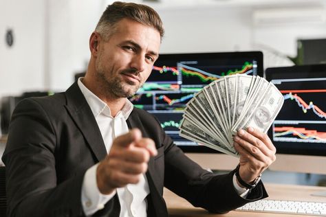 Premium Photo | Image of pleased businessman 30s wearing suit holding money fan while working in office with graphics and charts on computer Successful Man Photography, Man With Money, Business Man Photography, Working In Office, Greek Plays, Holding Money, Men's Study, Successful Man, Bitcoin Account