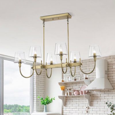 If you're looking to add a touch classic, elegant lighting to your home, this island light fits the bill. A lustrous vintage brass hints at old world charm and accentuates the slender lines curves and lines of the fixture. The clear glass shade emits the maximum amount of light to illuminate your space beautifully and with style. This island light is fashionable lighting done right. | Everly Quinn Antonique 6 - Light Vintage Brass Kitchen Island Pendant Glass in Yellow | 12.25 H x 42 W x 25 D in Linear Chandelier Over Kitchen Island, Brass Foot Rail Kitchen Island, Over The Sink Lighting Kitchen, Linear Pendant Light Over Island, Light Over Island, Over The Sink Lighting, Chandelier Over Kitchen Island, Kitchen Track Lighting, Brass Kitchen Island