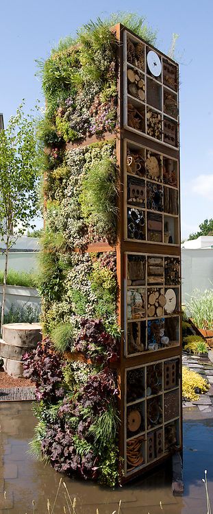 Tower containing living wall and bug boxes or insect hotels. “Future Nature” Garden, by Ark Design Management Ltd, RHS Chelsea Flower Show 2009. Bug Hotel Wall, Bee Hotel Design, Bugs Hotel, Insects Hotel, Garden For Bees, Bees Garden, Bug Box, Bug Garden, Future Nature