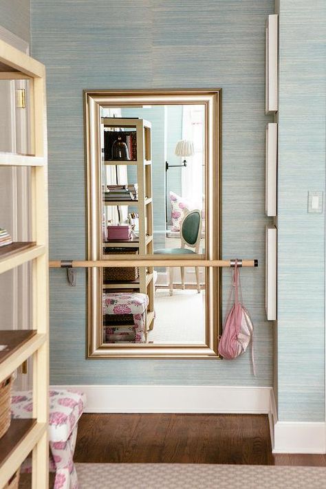 A silver leaf beveled mirror hung from a pale blue grasscloth wallpapered wall is fitted behind a ballet barre in an elegantly designed girl's bedroom. Grasscloth Wallpaper Bedroom, Ballet Bedroom, Dance Bedroom, Ballerina Bedroom, Ballet Room, Home Dance Studio, Bedroom Closet Doors, Shared Girls Bedroom, Bedroom Girls