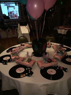 80th Birthday 50's theme sock hop | CatchMyParty.com Retro 50th Birthday Party, 80th Theme Party Ideas, 75 Birthday Theme Party Ideas, 1950s Birthday Party Ideas, Retro Table Centerpieces, Sock Hop Party Decorations, Motown Party Theme, Sock Hop Birthday Party, 50 Theme Party Ideas