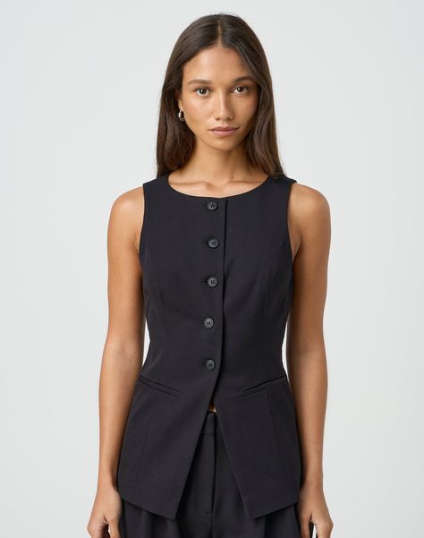 This tailored longline vest features a button through front, a rounded neckline and an adjustable back tie. Structured Vest Outfit, Black Work Wear Women, Button Front Vest Outfit, Corporate Lawyer Fashion, Tailored Vest Outfits For Women, Neck Tie Outfits For Women, Tie Outfits For Women, Work Outfits Black Women, Workwear 2023