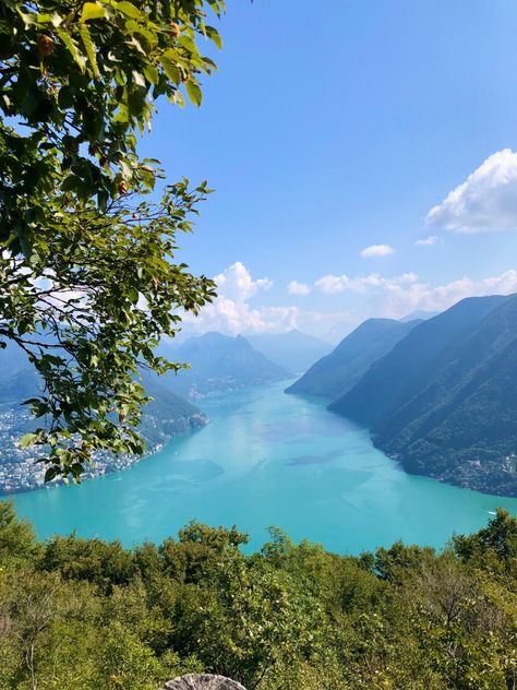 Picture of lake lugano running in between several hills/mountains 

Lugano, Switzerland, europe, europe aesthetic, European summer, european summer aesthetic, travel, aesthetic, summer, summer, vacation, summer aesthetic, summer in switzerland, summer in italy, euro summer, aesthetic, building, vacation vibes, summer vibes, vibes, travel inspo, lake, mountain, lake vibes, flowers, hike, hiking vibes, mountains Life In Switzerland Aesthetic, Summer In Switzerland Aesthetic, Montreux Switzerland Aesthetic, Switzerland Travel Aesthetic, Swiss Alps Aesthetic Summer, Lugano Switzerland Aesthetic, Lake Lugano Switzerland, Lucerne Switzerland Aesthetic, Switerzerland Summer