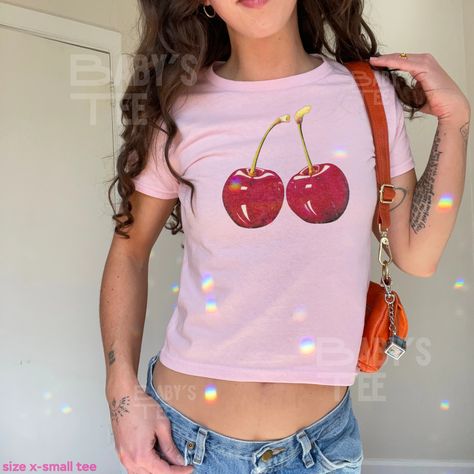 Short fit style y2k trendy baby tee with coquette aesthetic cherry graphic on the tee Graphic Tees Design Prints, Y2k Cherry, Baby Tee Aesthetic, Baby Tee Shirt, Shirt Coquette, Baby Tee Shirts, Cherry Baby, Baby Graphic Tees, Custom Tee