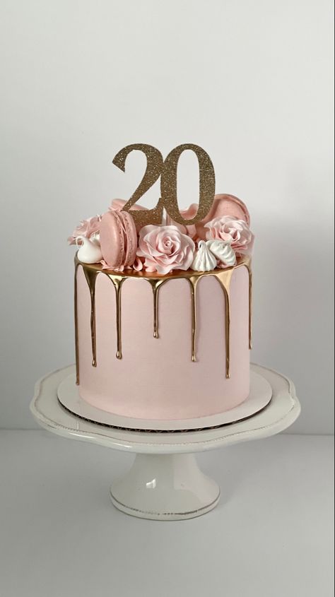 Pink cake with a gold drip. The top is decorated with pink sugar roses, pink macarons and white meringues. A sparkly, gold cake topper sits in the middle and reads “20”. Pink Cake Drip, Pink 20th Birthday, Rose Gold Drip Cake, Kue Disney, 20th Birthday Cake, Birthday Cake For Women Simple, Tårta Design, 19th Birthday Cakes, Modern Birthday Cakes