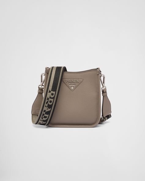 The sleek design of this leather mini shoulder bag is emphasized on the front by the metal triangle logo that adds an iconic note. The detachable logo-print woven tape shoulder strap emphasizes the contemporary character of the accessory. Fancy Sneakers, Tape Shoulder, Prada Mini, Prada Sneakers, Metal Lettering, Lettering Logo, Prada Leather, Prada Crossbody, Prada Crossbody Bag