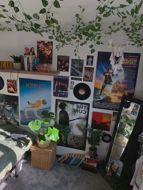 Y2k Posters For Room Grunge, Poster On Ceiling Bedrooms, Room Ideas With Album Covers, Room With Plants And Posters, Poster Wall Inspo Grunge, Plants And Posters Bedroom, Poster Placement Ideas Bedroom, Poster Covered Walls Bedroom, Wall Filled With Posters