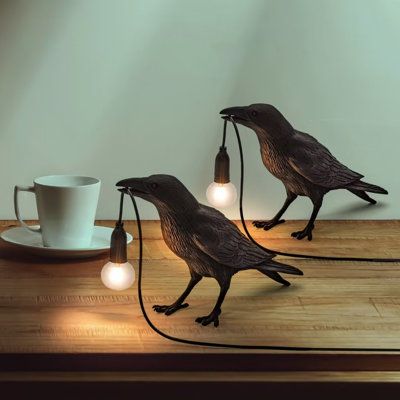 Introducing our unique crow-shaped lamp - the perfect addition to any space! Not only does it look great, but it's also energy-efficient, thanks to the LED technology used. Made from high-quality materials, this lamp is built to last and is sure to be a reliable lighting solution for years to come. Don't settle for an ordinary lamp, choose our crow-shaped lamp for a truly unique and eye-catching addition to your decor! | Winston Porter Albinson Table Lamp Novelty Lights Resin Crow Light Birds De Industrial Decor Living Room, Hubbardton Forge Lighting, Desk Lamps Bedroom, Small Desk Lamp, Novelty Lamps, Industrial Table Lamp, Novelty Lights, Globe Lamps, Bedroom Desk