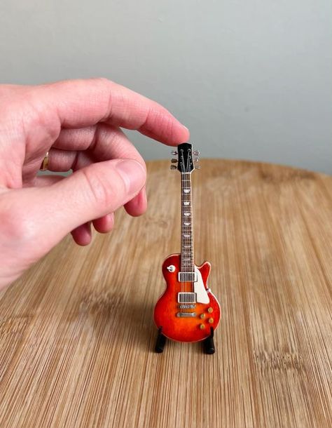 I made this 1:12 scale mini replica of my lifesize electric guitar! See how I made it on my instagram! #miniaturemodelmaking #miniatures #miniatureguitar #miniaturemaker #makeitmini #guitar Architecture Models, Miniature Guitars, Mini Guitar, Miniature Projects, Custom Guitar, Diy Dollhouse Furniture, Handmade Miniatures, Be Cool, Model Making