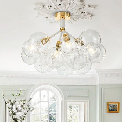 The 4-light clear glass bubble semi flush mount is a contemporary ceiling light that effortlessly combines style and practicality. Made of glass and metal, this modern piece showcases numerous clear glass globes with discreetly placed bulbs. Able to hold four E26 bulbs, this clear glass globe semi flush ceiling light beautifully illuminates any space, creating a stunning visual display from every angle. Whether turned on or off, this bubble semi flush ceiling light adds a sophisticated touch to Bubble Light Flush Mount, Glass Bulb Chandelier, Contemporary Ceiling Light, Bedroom Redo, Flush Mount Chandelier, Bubble Chandelier, Contemporary Ceiling, Glass Bubble, Bubble Lights