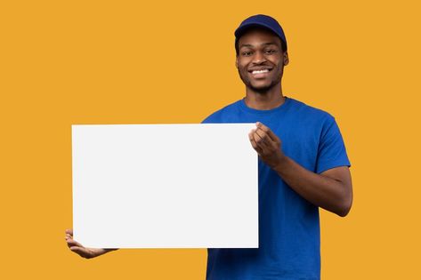 Shipment Service Promotion. Portrait of smiling bearded black delivery man in blue uniform holding and showing square empty blank board with template isolated on orange studio background Logos, Thumbnail Poses, Product Background, Product Poster, Blue Uniform, Advertising Board, Advertisement Poster, Bible Characters, Logo Wall