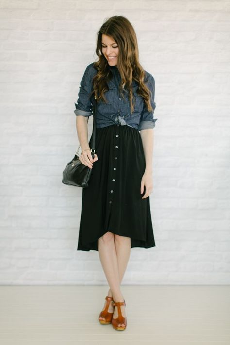 Button Midi Skirt Outfit, Denim Shirt Over Black Dress, Wearing A Shirt Over A Dress, Black Button Down Skirt Outfits, Dress With Button Up Shirt Over, Dark Chambray Shirt Outfit, Tie Shirt Over Dress, Black Dress With Denim Shirt, Dress With Top Over