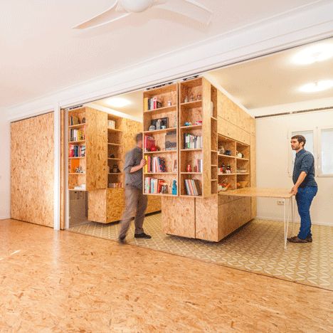 Sliding chipboard panels utilise space in Madrid apartment Diy Moveable Wall, Movable Walls Room Dividers, Moveable Furniture, Moveable Storage, Modular Library, Flexible Architecture, Shelves Library, Modular Room, Spanish Apartment