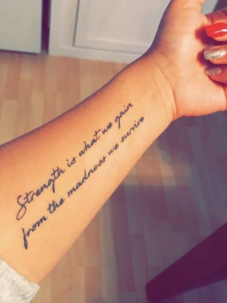 50 Best Arm Tattoo for Women in 2022 - The Trend Spotter Womens Tattoo Quote Ideas, Quote About Strength Tattoo, Tattoos With Sayings Inspiration, Women Tattoo Quotes Strength, Strength Women Tattoos, Tattoos On Strength, Womens Are Tattoos, Cute Tattoo Sayings For Women, Strength Word Art