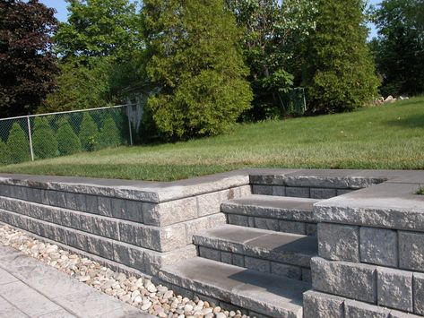 Steps and retaining wall accommodating to levels of patio Retaining Wall Steps Ideas, Diy Retaining Wall With Steps, Patio Step Down To Pool, Small Retaining Wall With Steps, Steps In Retaining Wall, Versa Lok Retaining Wall, Retaining Walls With Steps, Sunken Patio Retaining Walls, Raised Patio Ideas Retaining Walls