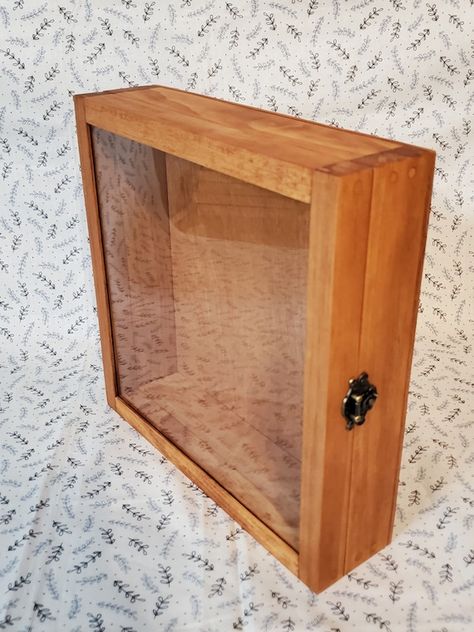 Welcome to my listing for this 10 x 10 x 2 1/2 Shadow Box  Display Case  Hinged Glass Lid  Memorial  Box Choice of Color Stain.The shadow box has a hinged glass lid.  It is made with Premium American Pine.  The wood we use is 3/4 inch thick.  We use antique bronze hinges and latch.You have a choice stain color, and wall hanging hardware.The example shadow box display case shown in the pictures above is stained with Gunstock.The inside measurements are:10 x 10 x 2 1/2 from glass to back.Outside m Large Shadow Box, Shadow Box Display Case, Wooden Box With Lid, Wooden Shadow Box, Diy Shadow Box, Glass Hinges, Box Hinges, Door Displays, Box Display