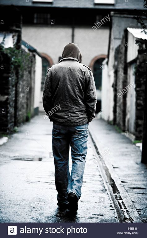 Download this stock image: Young man wearing a hooded jacket alone and isolated walking down an alleyway in a city UK seen from behind walking away - B6E886 from Alamy's library of millions of high resolution stock photos, illustrations and vectors. Walking Behind Reference, Walking Through Door Reference, Guy Walking Reference, Walking From Behind Reference, Man From Behind Reference, Man Walking From Behind, Man From Behind Drawing, Man Walking Reference, Character From Behind