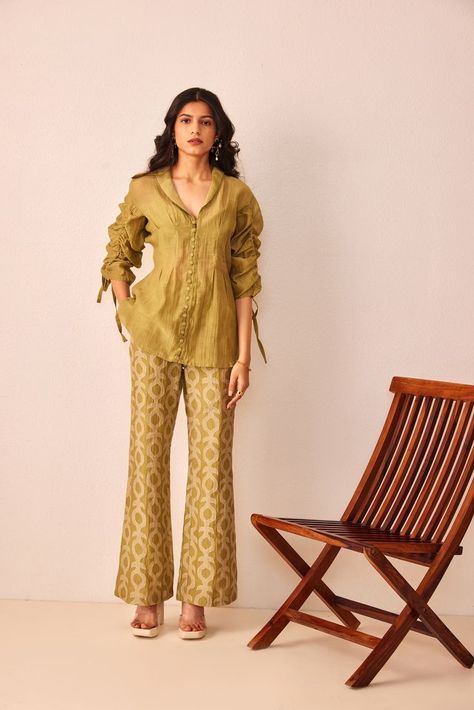 A moment of appreciation for iconic Mila co-ord set, composed in fine green chanderi. The top features statement sleeves with pullout details and darts near the waist for that feminine fit. The statement trousers are appliqué and are here to stay. Pair this with a fresh blow dry and matching shoes to breeze through the summer events. Co Ords Outfits Indian, Co Ord Sets Pants, Night Out Looks, Satin Tops, Co Ords Outfits, Coord Sets, Casual Cotton Top, Trendy Outfits Indian, Womens Trendy Dresses