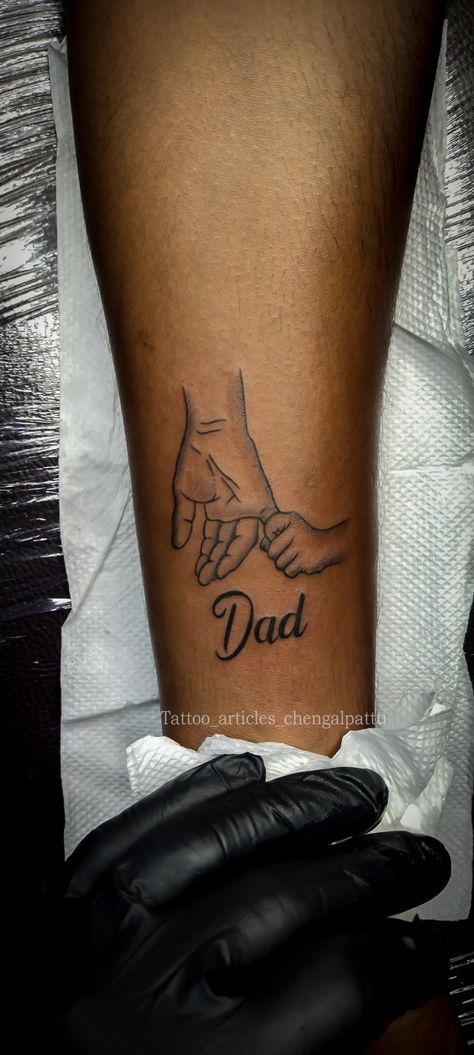 Dad son hand folding Tattoo Tattoo Designs For Father And Daughter, Father Daughter Hand Tattoos, Father And Son Hands Tattoo, Daddy Tattoos For Daughter My Dad Tat, Tattoo Ideas For Dads With Sons, Tattoo Ideas Sentimental, Small Tattoo Ideas For Parents, 2 Hands Touching Tattoo, Parents Bday Tattoo