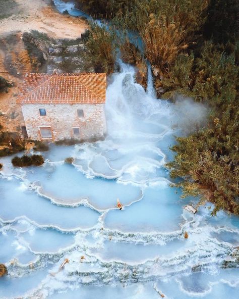 The rolling #Tuscan hillside is known for its vineyards, scenic landscapes, and artistic legacy. One of its better-kept secrets sits just outside the small village of #Saturnia on the grounds of an old #mill. For centuries, locals and visitors alike have flocked to the #CascatedelMulino, a #beautiful, cascading thermal #spring in the charming #Italian Province of #Grosseto. Saturnia Italy, Italy Magazine, Natural Spa, Thermal Spring, Les Cascades, Scenic Landscape, Enchanted Forest, Travel Lifestyle, Aerial View