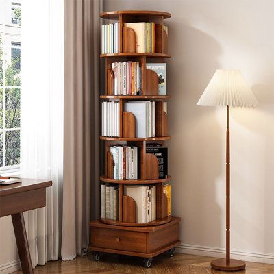 This 360-degree rotating bookshelf is made with high-quality non-toxic wood . Featuring a 5-tier design, you can organize a variety of different items with ease such as books, vases, albums, etc. The design of the casters allows the bookshelf to move freely. It can be moved or locked, making it more convenient. | Red Barrel Studio® 68.1" H 5 Tier Rotating Rolling Bookcase w / 1 Drawer Wood in Brown | 68.11 H x 18.11 W x 18.11 D in | Wayfair Bookshelves With Bench Seat, Cozy Built Ins, End Table Bookshelf, Unique Bookcases Creative Bookshelves, Floating Bookshelf Above Bed, Stacking Books On The Floor, Modern Antique Decor Living Room, Red Vintage Decor, Bookshelf Desk Combo