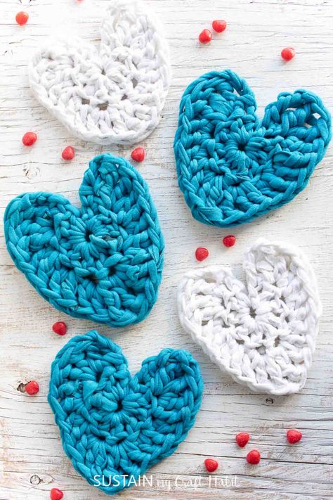 This easy free crochet pattern is a great way to use up t-shirt yarn or yarn scraps to make simple coasters, garlands and other projects. It's the perfect beginner crochet project and includes how-to video tutorial. Free Crochet Heart Patterns, Crochet Heart Patterns, Free Heart Crochet Pattern, Crochet Cup Coaster, Easy Beginner Crochet Patterns, Coaster Projects, Yarn Scraps, Crochet Butterfly Pattern, Tshirt Yarn