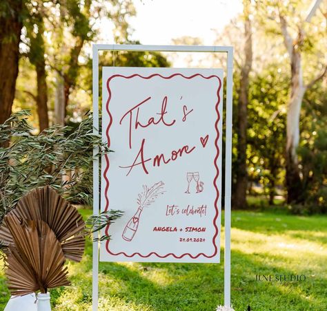 Unique Engagement Party Welcome Sign Hand written Hand-painted Pizza Rehearsal Dinner Welcome To our engagement Decor Couple Shower Pizza Theme Wedding DIY Bridal Shower Bachelorette Party Adult Birthday Welcome Board Hens Party Decoration -------------------- The listing is for Hand drawn That's Amore Engagement Party Wedding Welcome Sign Template. This design features my hand lettered "That's Amore" and trendy illustration style with champagne bottle, engagement ring and wavy border, a great w Backyard Engagement Decor, Thats Amore Sign, Pizza Engagement Party Decor, Minimalist Engagement Party Decor, Italian Engagement Party Ideas, Outdoor Couples Shower Decorations, Engagement Party Styling, Pizza Theme Engagement Party, Pizza Themed Bachelorette Party