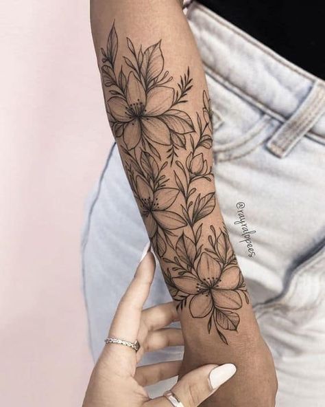 120 Pretty And Girly Half-Sleeve Tattoo Ideas For Females Delicate Flower Tattoo Arm Half Sleeves, Lilly Flower Tattoo Sleeve, Grey Wash Flower Tattoo, Half Sleeve Tattoos For Women Christian, Daisy Tattoo Half Sleeve, Types Of Floral Tattoos, Floral Wrist And Hand Tattoo, Footprint With Flowers Tattoo, Flower Arm Tattoo Stencil