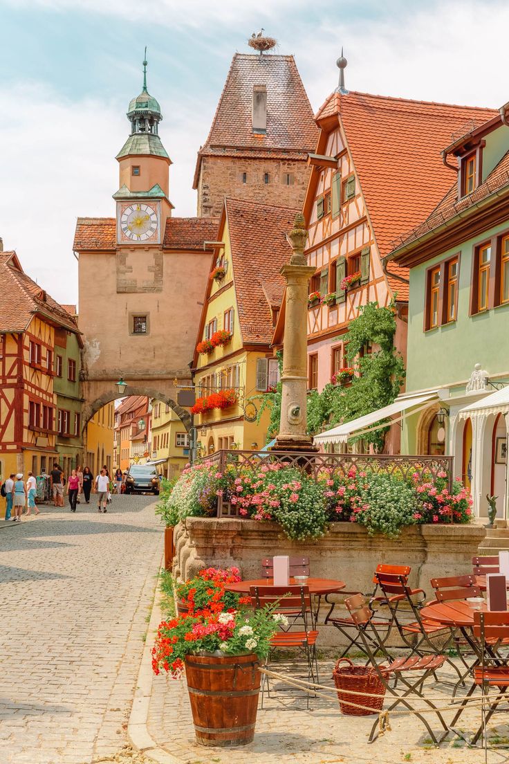 an image of a town with flowers in the foreground