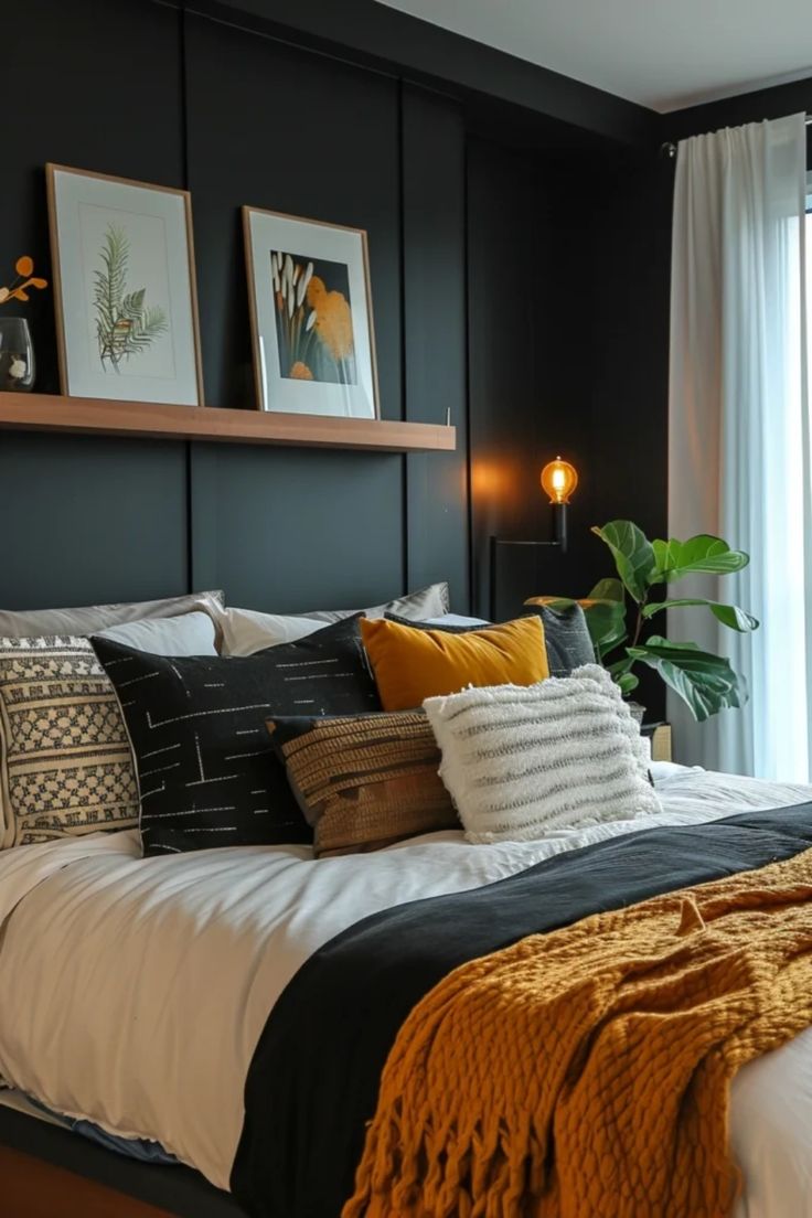 a bedroom with black walls, white bedding and yellow throw pillows on the bed