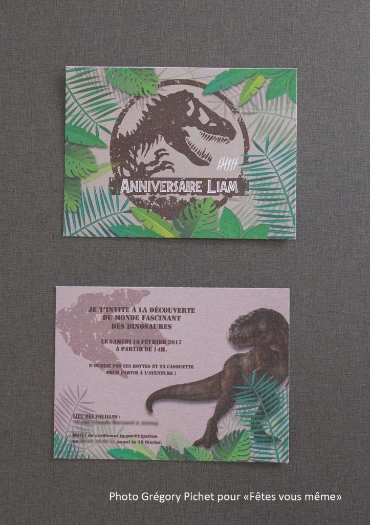 two business cards with an image of a t - rex on one side and another in the other