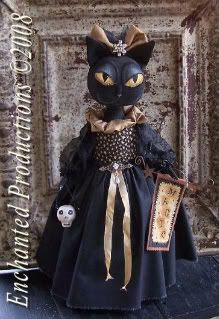 a black cat doll in a dress with gold accents and a skull on the floor