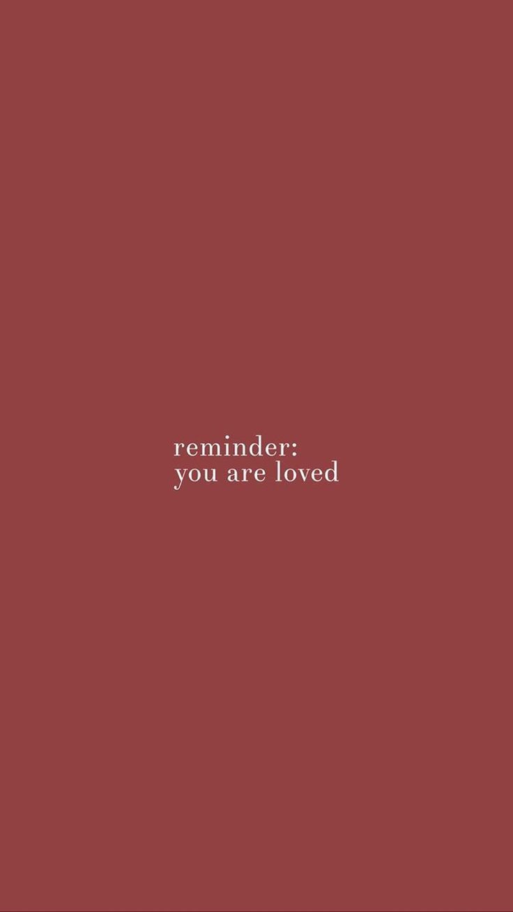 the words reminder you are loved on a red background