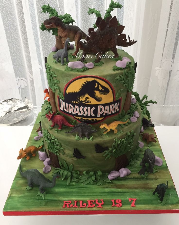 a dinosaur themed birthday cake on a table